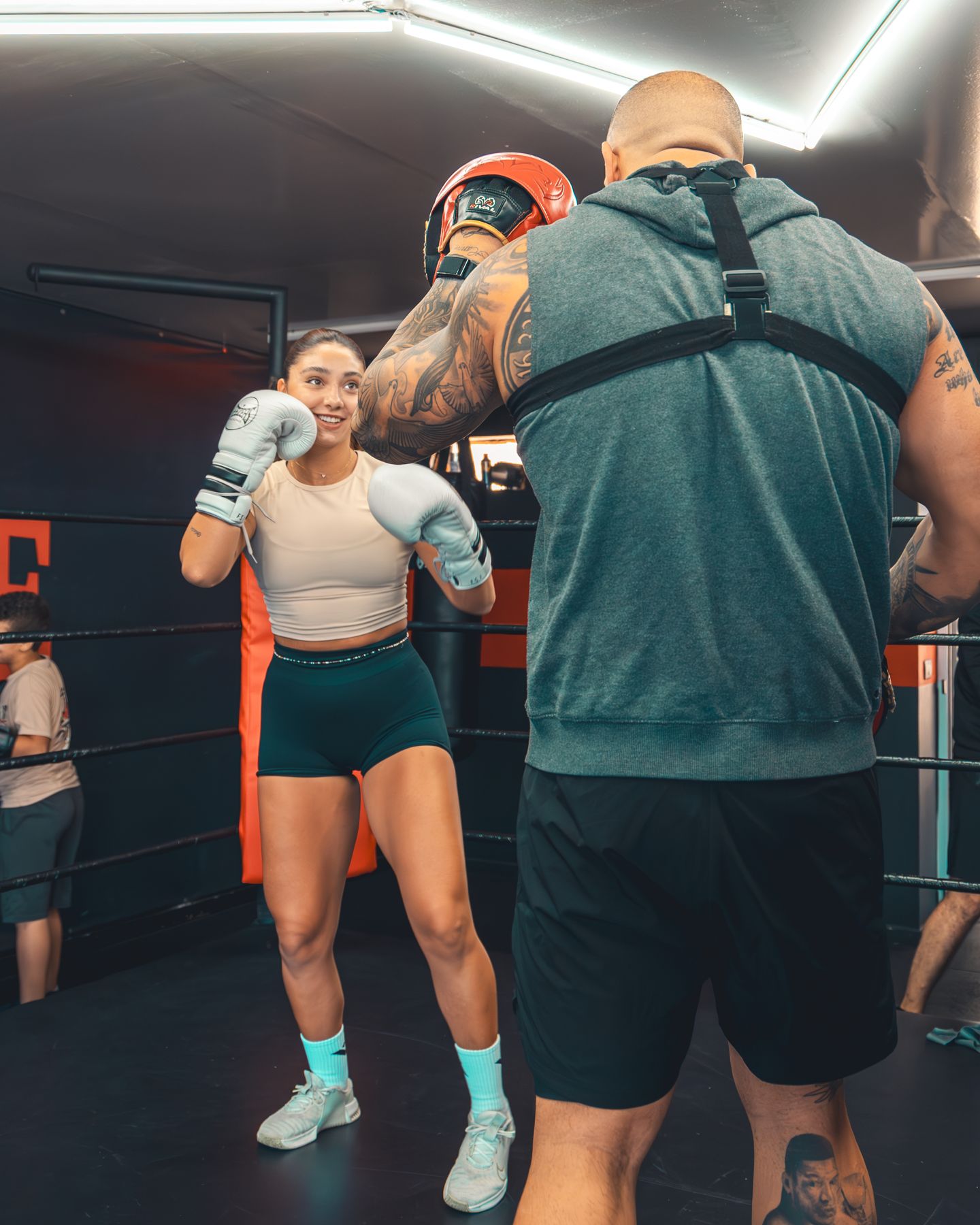 Coach and fighter training on pads