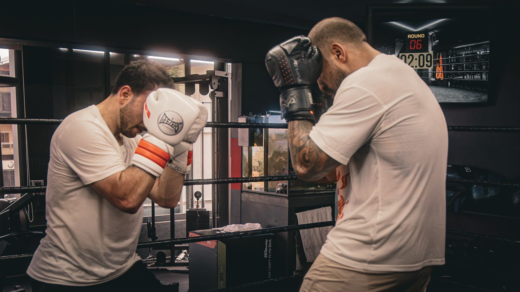Two boxers sparring in front of the ring